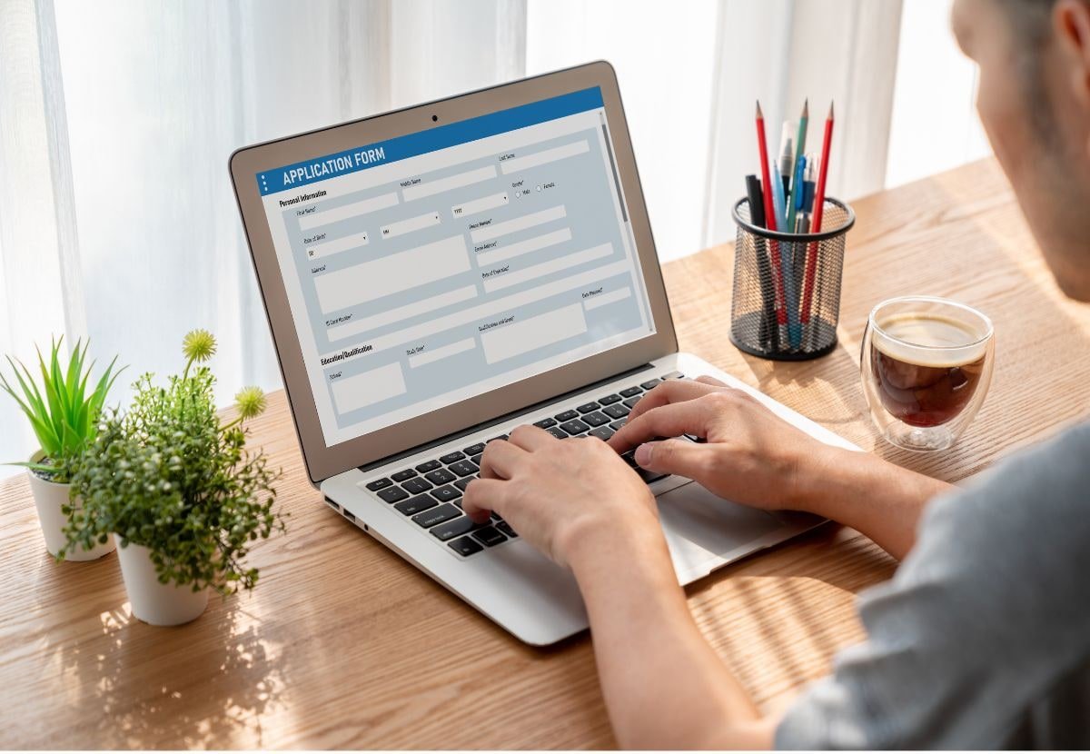 Laptop displaying a business application form on a desk