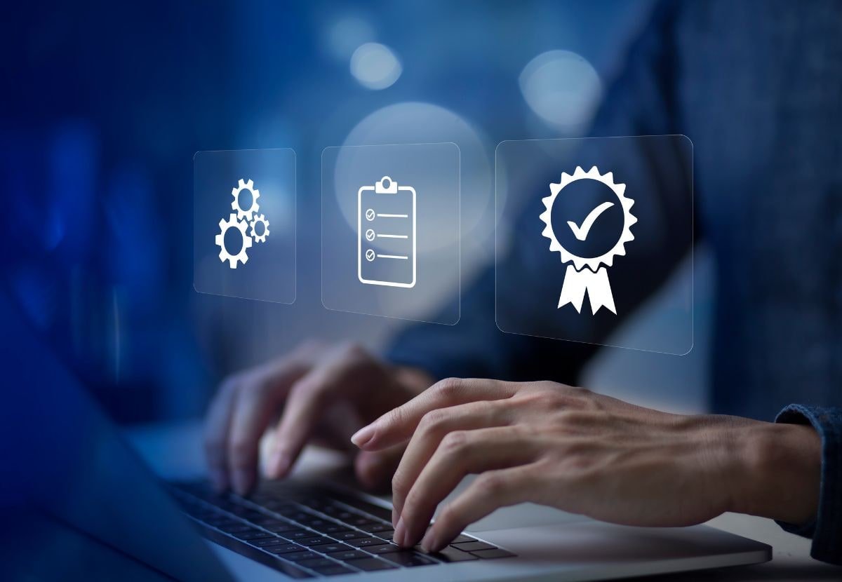 Person typing on a laptop with quality, service, and certification icons overlaid