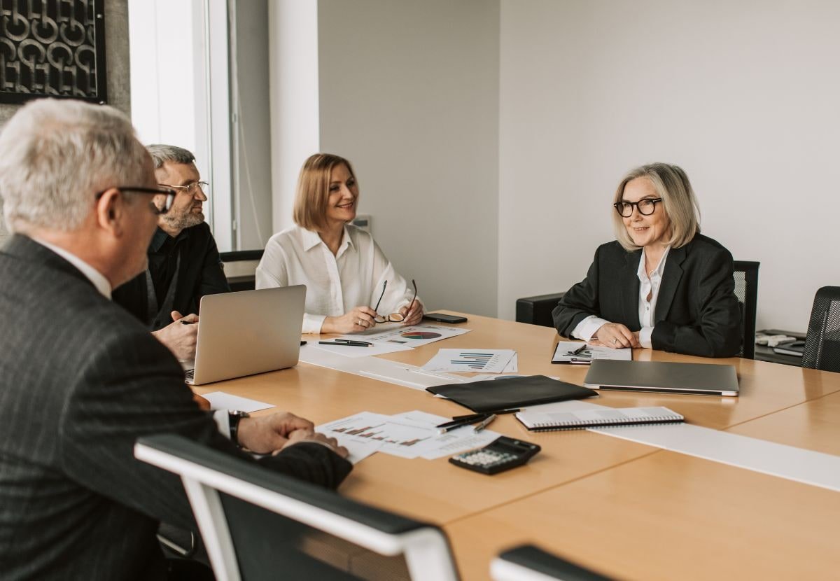 Two professionals reviewing financial charts and graphs at a table